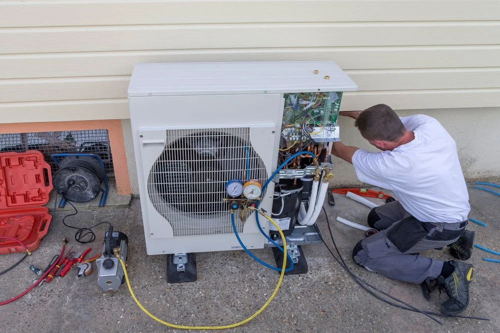 HVAC technician fixing heat pump